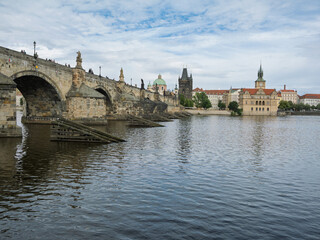 Fototapeta premium Charles Bridge Arch And Sculptures Over Vltava River With Lesser Town Towers In Background, Prague, Czech Republic