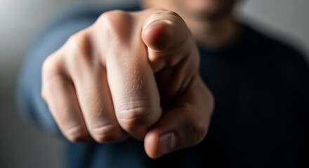 Naklejka premium Close up of a hand pointing directly at the viewer.