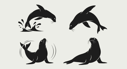 Set of four black silhouettes of sea lions and seals in various poses. © Anggara
