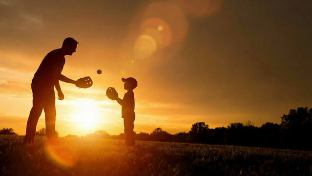 Father and child silhouette playing at golden sunset