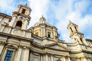 Obraz premium Baroque church facade with grand dome and twin towers under dramatic sky