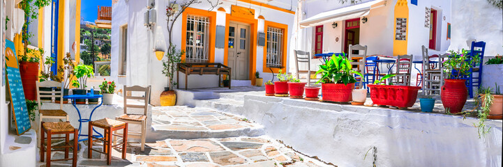 Paros Greece. Panorama 9k of Lefkes Village. Traditional Cycladic Street with White Stone Houses and Outdoor Cafe under Pine Trees with Colorful greek Chairs. High Resolution World Print.