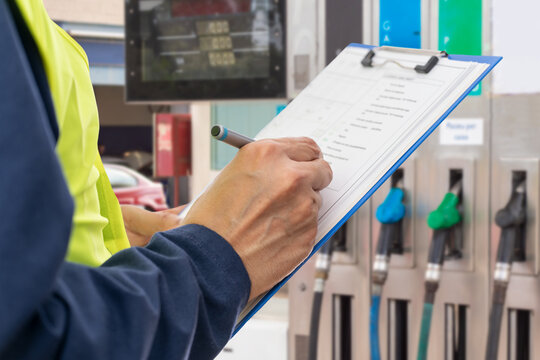 Engineer with clipboard for checklist, inspection notes or control of pump at gas station, fuel and transport cost for energy. Man writing documents for project management or supervisor paperwork.