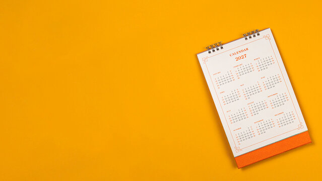Calendar year 2027 schedule on yellow background.
2027 calendar planning appointment meeting concept. 
copy space.
top view.
