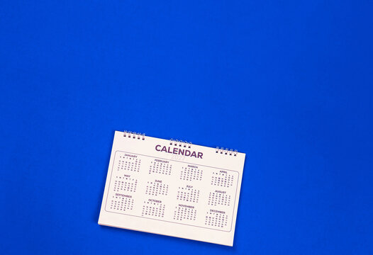 Calendar year 2027 schedule on blue background.
2027 calendar planning appointment meeting concept. 
copy space.
top view.