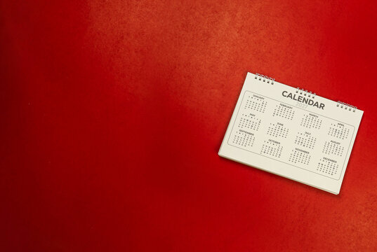 Calendar year 2027 schedule on red background.
2027 calendar planning appointment meeting concept. 
copy space.
top view.