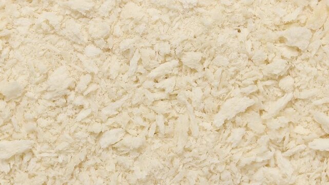 pile of breadcrumbs rotating slowly, crunchy coating ingredient for deep frying, top view shot