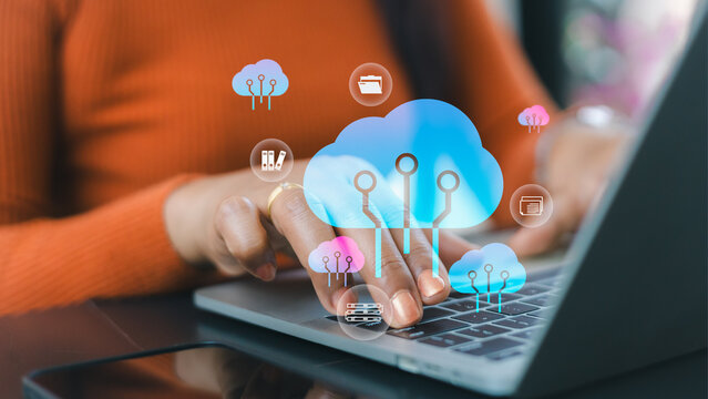 Cloud computing data storage concept.Digital transformation for small business.Secure online database management system.Businesswoman working on laptop with cloud icons.