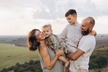 Fototapeta premium Happy Family of Four Enjoying Quality Time Together Outdoors in Nature