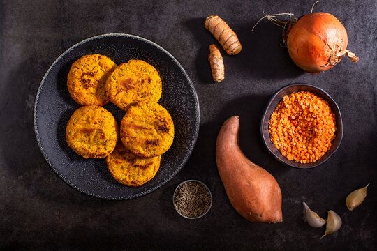 Raw vegetables on textured dark surface