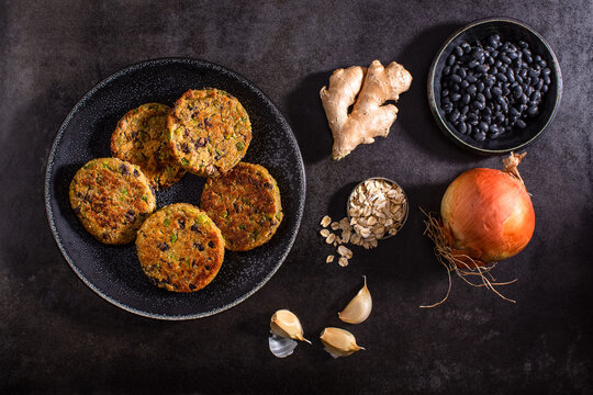 Raw vegetables on textured dark surface