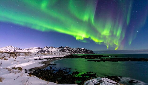 Spectacular Aurora Borealis Display Over a Snowy Icelandic Landscape.