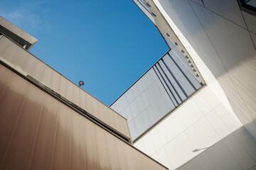 Low angle architectural photograph of modern building exteriors with geometric lines against a...