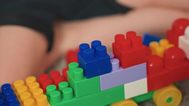 White son focused stacking colorful blocks closeup, handson precision and careful alignment, fine motor practice with bright plastic bricks, calm concentrated play, developmental learning and sensory