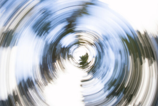 Abstract circular motion blur of spring flowers and green foliage creating a creative spin effect in a garden