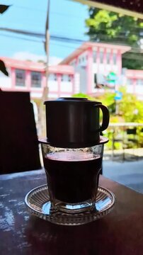 4K Vietnam Drip Coffee Brewing Process with Metal Phin Filter and Condensed Milk. Optimized for cafe menu digital displays, culinary documentaries, coffee shop marketing, and F&B social media content