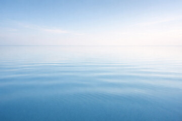 Obraz premium Serene Azure Horizon: A minimalist composition of tranquil water meeting a soft, diffused sky. This image evokes feelings of calmness, peace, and boundless freedom.