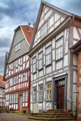 Fototapeta premium Street with half timbered houses in Schlitz Germany. Traditional architecture under cloudy sky in daylight