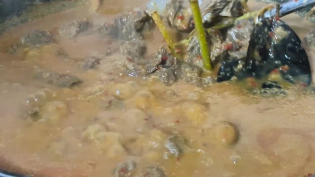 A close-up video of the process of cooking rendang. This legendary Indonesian dish is rich in spices.