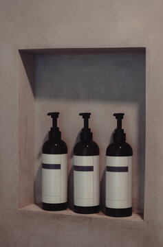 A modern display of stylishly packaged bath products arranged neatly in a niche, signifying quality and contemporary design in personal care items for any bathroom.