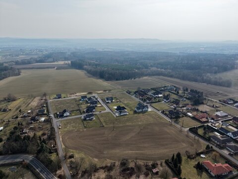 Scenic aerial view with homes. Elevated perspective showing rural homes and patchwork landscape