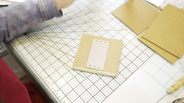 Woman's hands gluing cardboard for a scrapbook