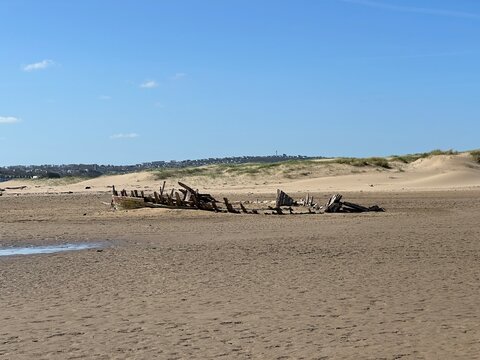 shipwrecked wooden boat on the beach 