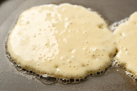 Pancakes cooking on griddle 