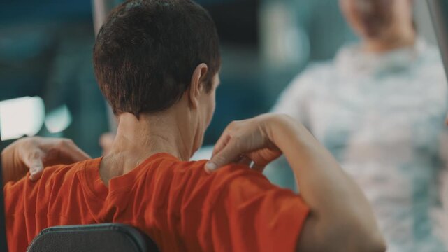 Senior man experiencing shoulder pain during gym workout