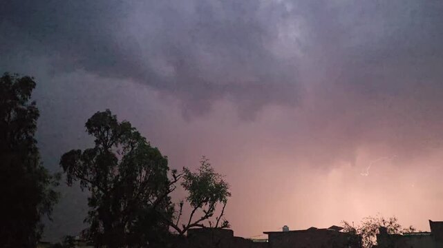 A dark scene featuring a lightening & thunder faintly illuminated object with a noticeable reflection and subtle highlights in the background