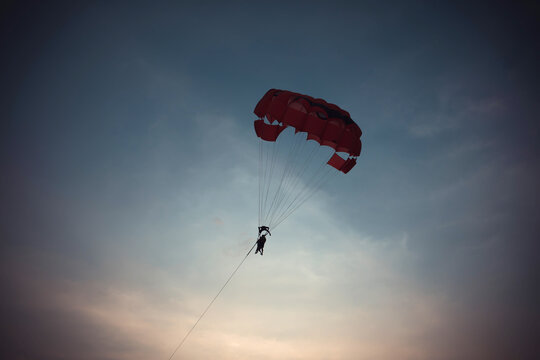 Parasailing Activity in the Twilight Sky Over the Sea at Sunset