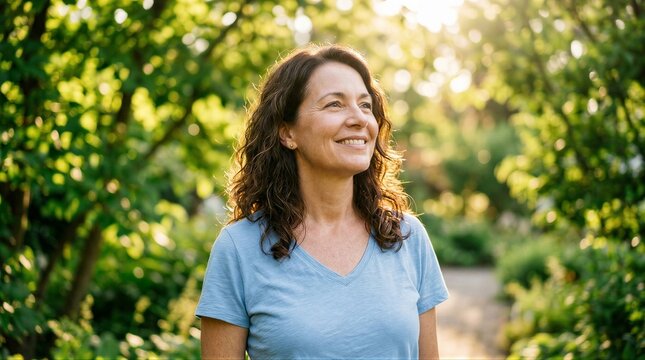 Mature woman smiling looking away in garden
