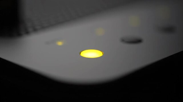 Close-up of a glowing indicator light changing color from red to green, indicating status.