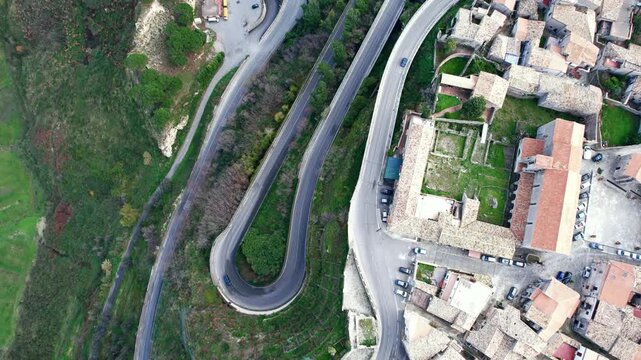 An aerial view of Gerace, Calabria, southern Italy, April 7, 2026. The medieval village is perched on a cliff. A drone view of the winding roads of this picturesque Italian hill town in Calabria.
