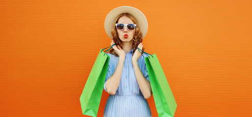 Stylish beautiful happy woman standing with colorful shopping bags