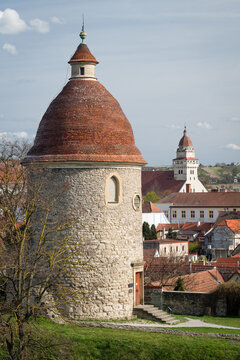 Detail of the historic Romanesque St. George Rotunda in Skalica, Slovakia, with a traditional tiled roof and church towers in the background