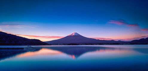 Landscape image of Mt. Fuji over Lake Kawaguchiko at sunrise in Fujikawaguchiko, Japan.