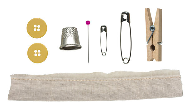 Sewing tools set with buttons, thimble, pins, safety pins, wooden clothespin and fabric strip with seam, isolated