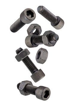 Black, hardened round-head bolts for a special internal Allen key fall in space. Isolated on white.