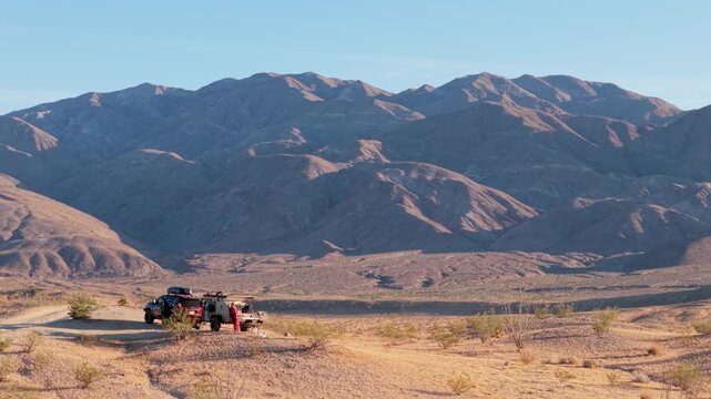 A teardrop camper and SUV travel through Anza Borego Desert State Park enjoying the Thimble Trail during daylight.