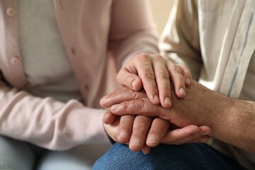 Fototapeta premium Grandfather and his granddaughter holding hands, closeup