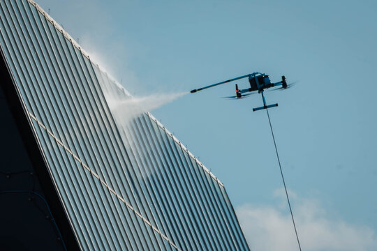 Drone Performing High-Rise Building Facade Window Washing