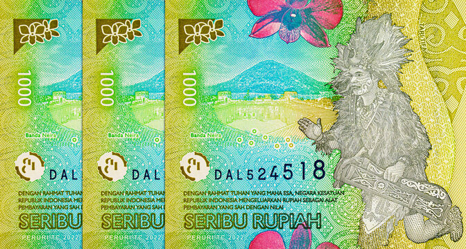 1000 Rupiah Indonesia with the image of the Tari Tifa dance and a traditional instrument.. Paper money of Indonesia.
