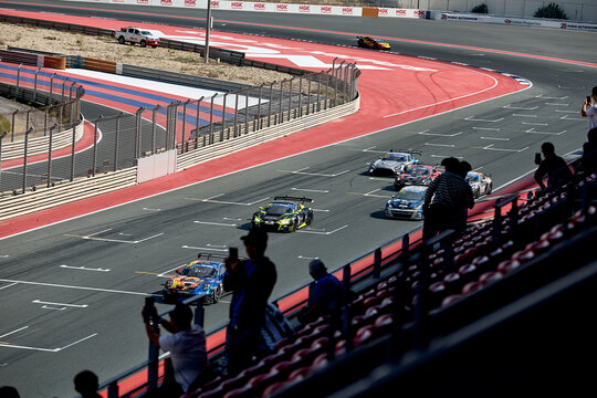 UAE, Dubai, 18 January 2026: 24h series racing supercars on the circuit, Battle of the teams, long exposure photography, supercars drive past at high speed, pitstops, training runs, watching people, 