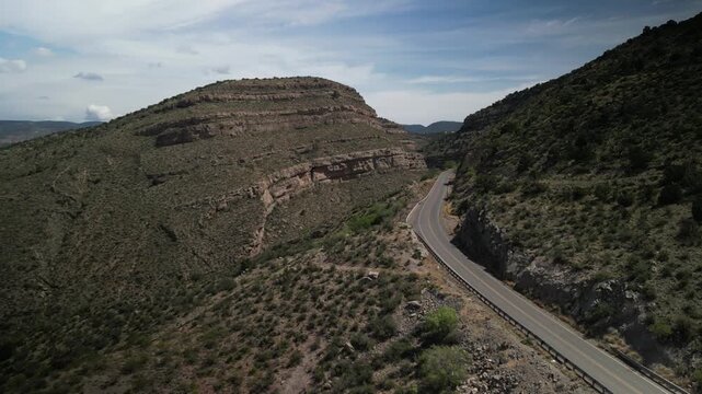 Aerial above canyon on way to High Rolls New Mexico in high desert hills in spring