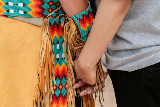 Hands Holding Traditional Woven Textile Showing Connection and Craftsmanship