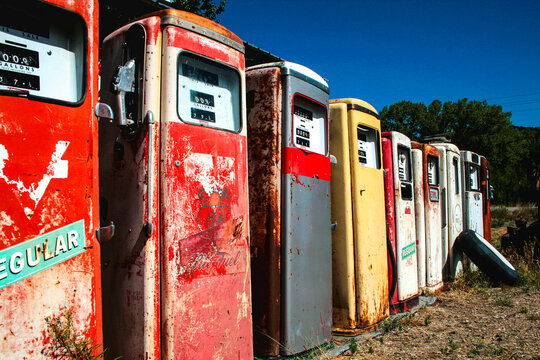Vintage gas pumps lined up in rural landscape, Route 66 Americana
