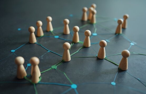 Wooden figures connect on abstract network graph. Represents teamwork, communication, business connections. Illustrates collaboration, corporate structures for team building, project planning.