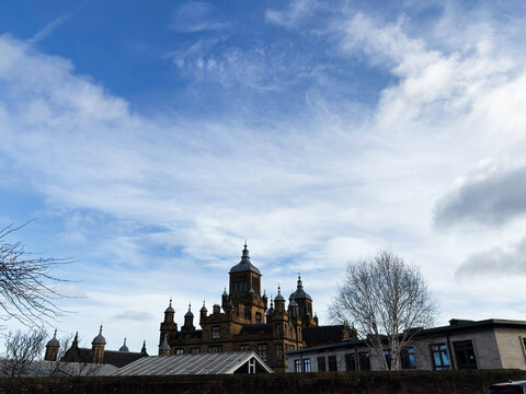 Historic sandstone Stewart's Melville College and turreted skyline in Edinburgh, Scotland, UK under a dramatic cloudy blue sky