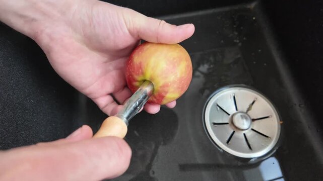 Removing apple core with tool close up process